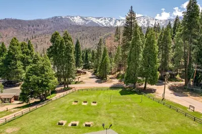 an aerial view of a park with mountains in the background at Camp Nelson Lodge Room 9 in Ponderosa
