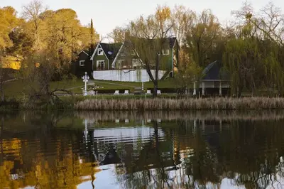 a house on the shore of a body of water at Lakefront Cottage at Lakewood in Auburn