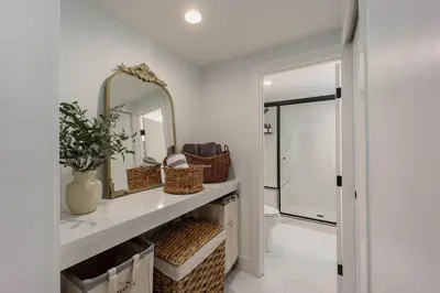 a bathroom with a sink and a mirror at Lakefront Cottage at Lakewood in Auburn