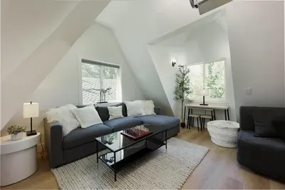 a living room with a couch and a table at Lakefront Cottage at Lakewood in Auburn