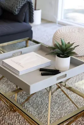 a coffee table with a book and a plant on it at Treehouse Overlook at Lakewood in Auburn
