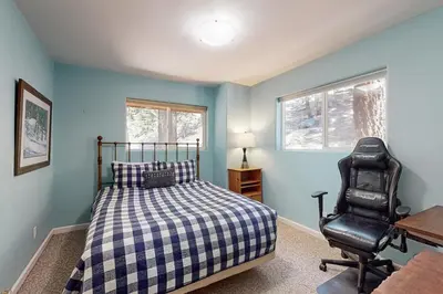 a bedroom with a bed and a desk and a chair at Summit Sanctuary in Stateline