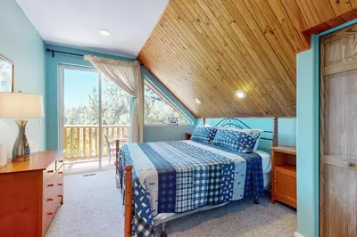 a bedroom with a bed and a wooden ceiling at Summit Sanctuary in Stateline
