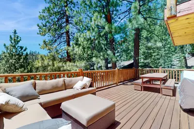 a patio with a couch and a table on a deck at Summit Sanctuary in Stateline