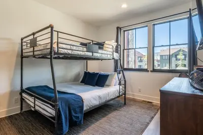 a bedroom with two bunk beds and a window at Creekhouse 1353 in Mammoth Lakes