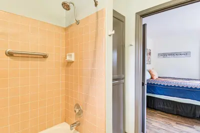 a bathroom with a shower and a toilet and a bed at Yosemite Wellbeing Retreat on 5 Acres with Mtn Views in Ahwahnee