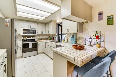 a kitchen with white cabinets and a counter top at Yosemite Wellbeing Retreat on 5 Acres with Mtn Views in Ahwahnee