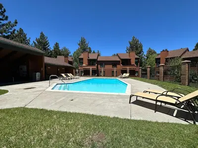 a swimming pool in a yard next to a house at Sunrise #33 condo in Mammoth Lakes