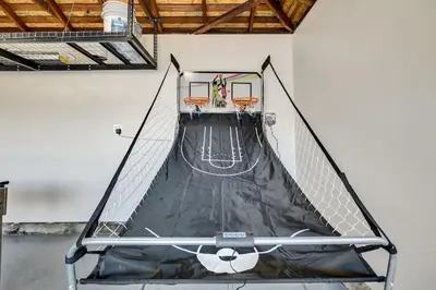 an indoor basketball court in a white wall at Mid Century Wineries Game Room in Lodi