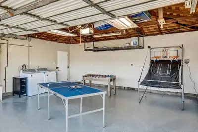 a room with a ping pong table in it at Mid Century Wineries Game Room in Lodi