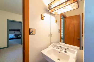 a bathroom with a sink and a mirror at Camp Richardson Resort in South Lake Tahoe