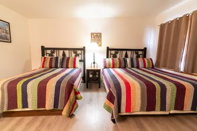 a bedroom with two beds with striped blankets at Camp Richardson Resort in South Lake Tahoe