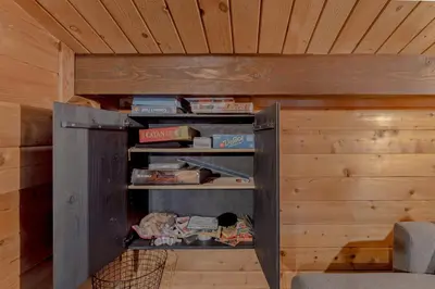 a book shelf in a wooden room with books at 3BR with Sauna & Lake Views, 2 miles to Beach in Tahoe City