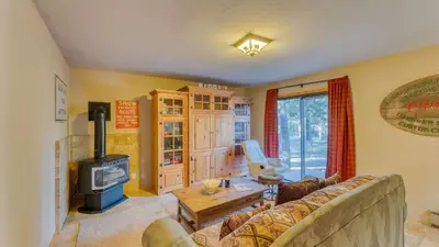 a living room with a couch and a wood stove at Paige Meadow by AvantStay Near Lake Tahoe City in Tahoe City