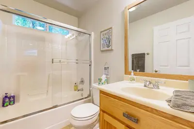 a bathroom with a shower and a toilet and a sink at Fire Pit, Near Lake Evergreen Escape in Arnold in Arnold