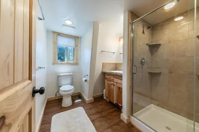a bathroom with a toilet and a shower at 10th Mountain Home - 4BR Tahoe Donner w Hot Tub, HOA amenities! in Truckee