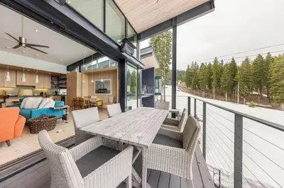 an open deck with a wooden table and chairs at Elevation Ski-in, Ski-out in Northstar w Private Hot Tub & HOA Amenities in Truckee