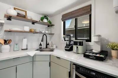 a kitchen with white counter tops and a sink at Lake Isabella A frames in Lake Isabella