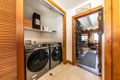 a laundry room with a washer and dryer at Reflections Lakeview Cabin - Private Beach Access, Hot Tub & Buoy! in Carnelian Bay