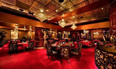 a dining room with tables and chairs and chandeliers at Peppermill Resort Spa Casino in Reno