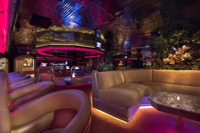 a room with a couch and a bar with lights at Peppermill Resort Spa Casino in Reno