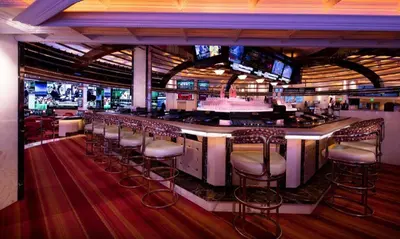 a bar with bar stools in a restaurant at Peppermill Resort Spa Casino in Reno