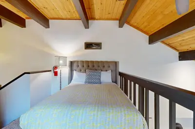 a bed in a bedroom with wooden ceilings at Pine in the Sky in Truckee
