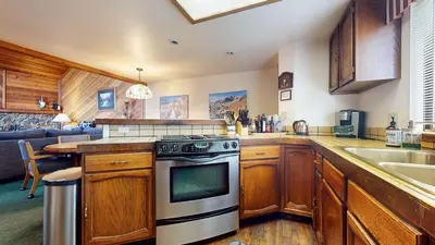 a kitchen with a stove and a sink at Mammoth Sierra Townhomes #23 condo in Mammoth Lakes