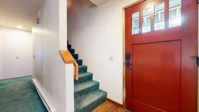 a stairway with a wooden door and a stair case at Mammoth Sierra Townhomes #23 condo in Mammoth Lakes
