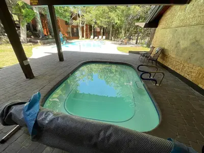a swimming pool with a hot tub in a hammock at Canyon Lodge properties by 101 Great Escapes in Mammoth Lakes