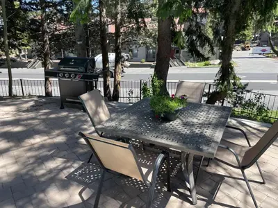 a black table and chairs with a grill and a table with a plant at Canyon Lodge properties by 101 Great Escapes in Mammoth Lakes