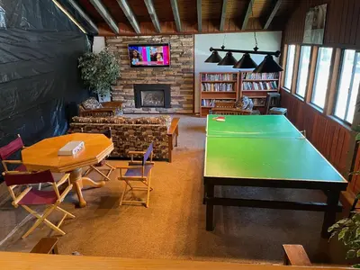 a room with a ping pong table and a fireplace at Canyon Lodge properties by 101 Great Escapes in Mammoth Lakes