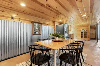a dining room with a table and chairs at The Pine Loft | Yosemite in North Fork