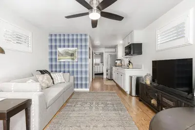 a living room with a couch and a flat screen tv at Mountain View Apartment in North Fork