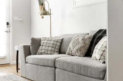 a gray couch with pillows in a living room at Mountain View Apartment in North Fork