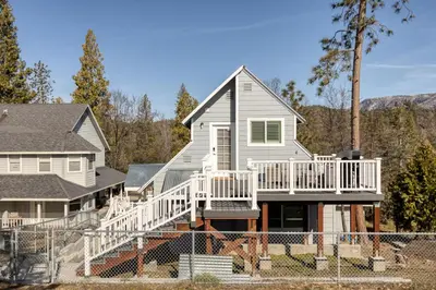 a house with a white deck and stairs at Mountain View Apartment in North Fork