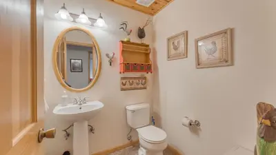 a bathroom with a sink and a toilet and a mirror at Tahoe Vista by AvantStay Central Location Patio in Tahoe Vista