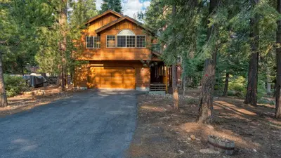 a house in the woods with a driveway at Tahoe Vista by AvantStay Central Location Patio in Tahoe Vista