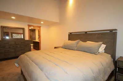 a bedroom with a bed with a dresser and a mirror at Tamarack 39 in Mammoth Lakes