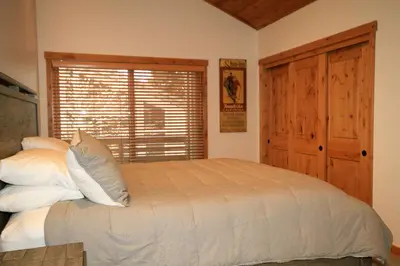 a bedroom with a bed with white pillows and a window at Tamarack 39 in Mammoth Lakes