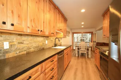 a large kitchen with wooden cabinets and a sink at Tamarack 39 in Mammoth Lakes