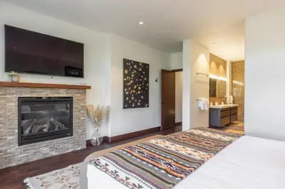 a bedroom with a bed and a fireplace at Snowcreek V 731 in Mammoth Lakes