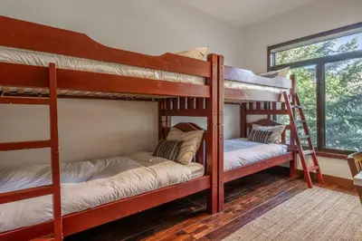 two bunk beds in a room with a window at Snowcreek V 731 in Mammoth Lakes