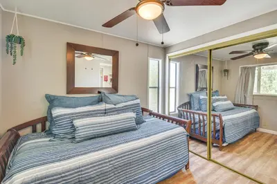 a bedroom with two beds and a mirror at La Grange Home with Covered Patio and Gas Grill! in La Grange