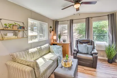 a living room with a couch and a chair at La Grange Home with Covered Patio and Gas Grill! in La Grange