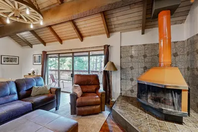 a living room with a fireplace and a couch at Walk to Golf and Restaurants Serene Twain Harte Gem in Twain Harte