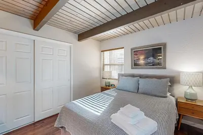 a bedroom with a bed and a white door at Walk to Golf and Restaurants Serene Twain Harte Gem in Twain Harte