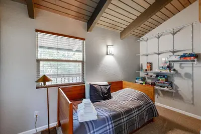 a bedroom with a bed and a window at Walk to Golf and Restaurants Serene Twain Harte Gem in Twain Harte