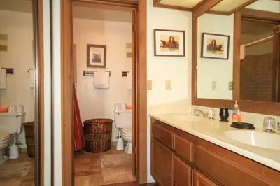 a bathroom with a sink and a toilet and a mirror at Mountainback 68 2 bedroom with loft in Mammoth Lakes