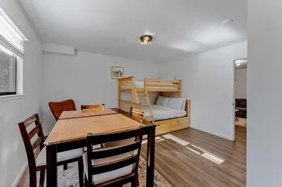 a dining room with a table and a bunk bed at Modern 3BR Carnelian Bay Retreat in Carnelian Bay